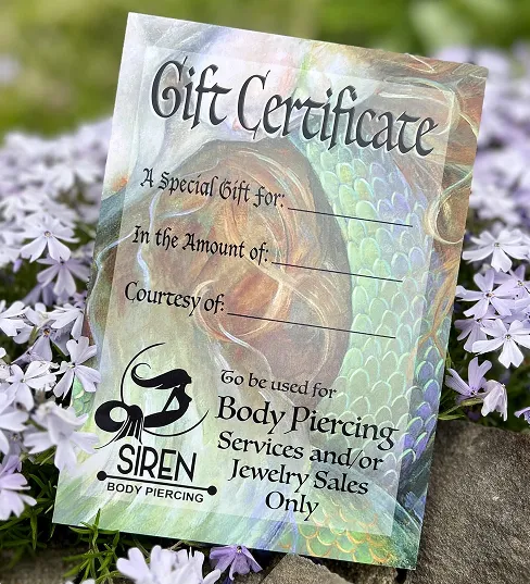 A gift certificate resting on a bed of flowers
