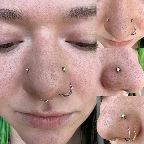 A close-up of a septum piercing with a small ring